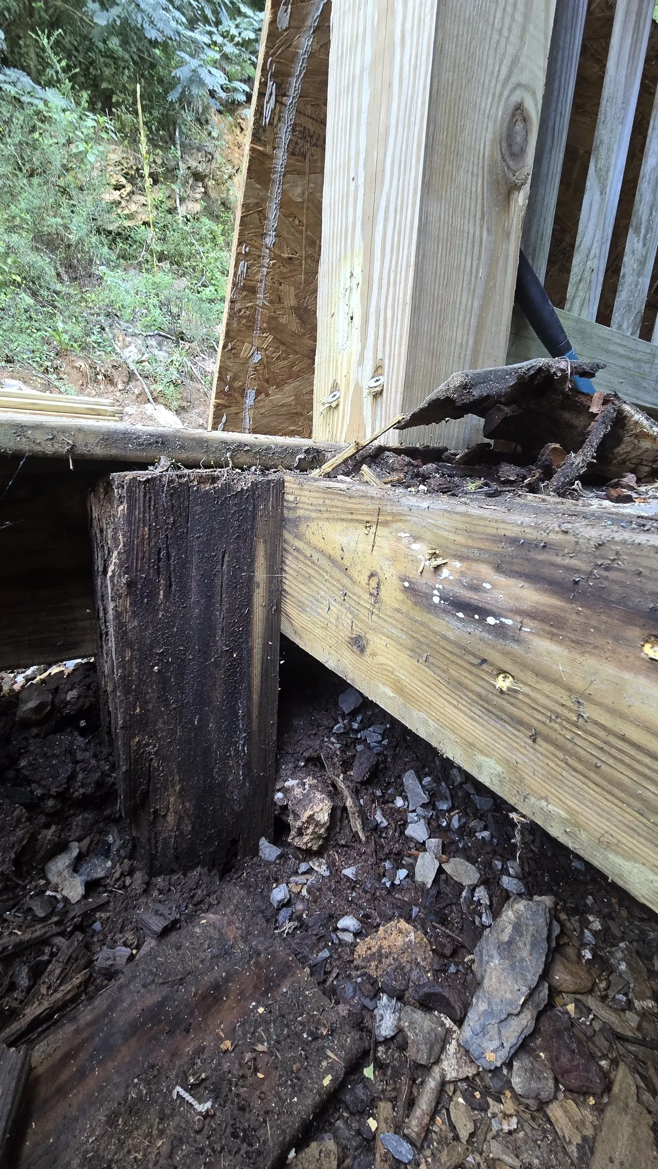 Rotted bottom of a post next to new lumber