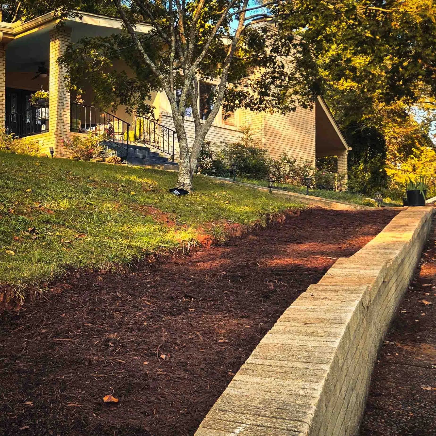 Fresh mulch along a block retaining wall, Oak Ridge, TN